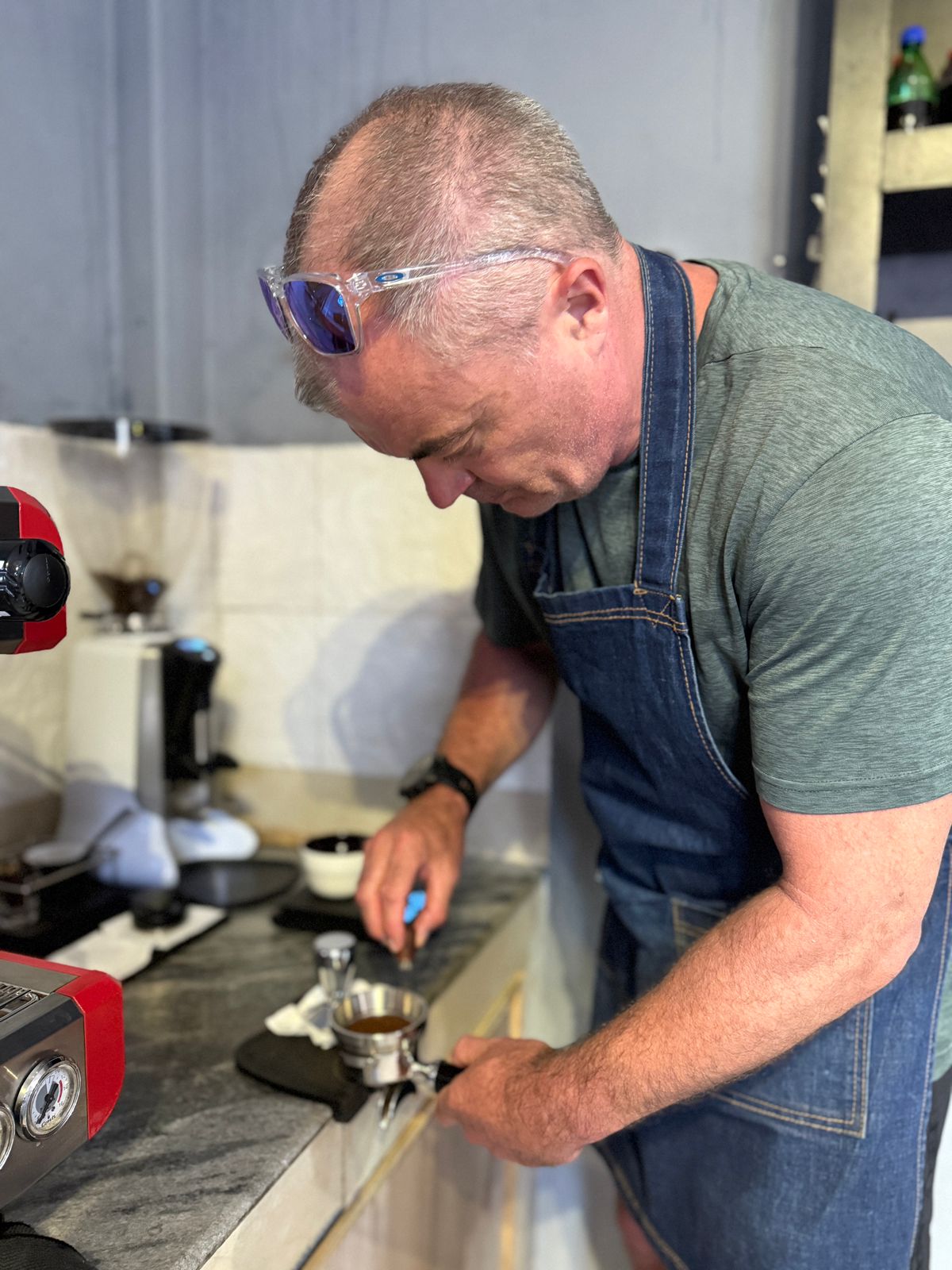 Smiling barista pouring latte art
