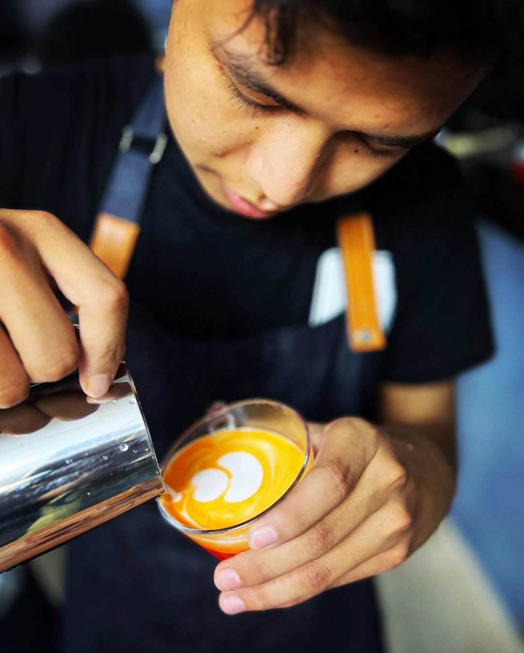 Barista pouring coffee into a pour-over